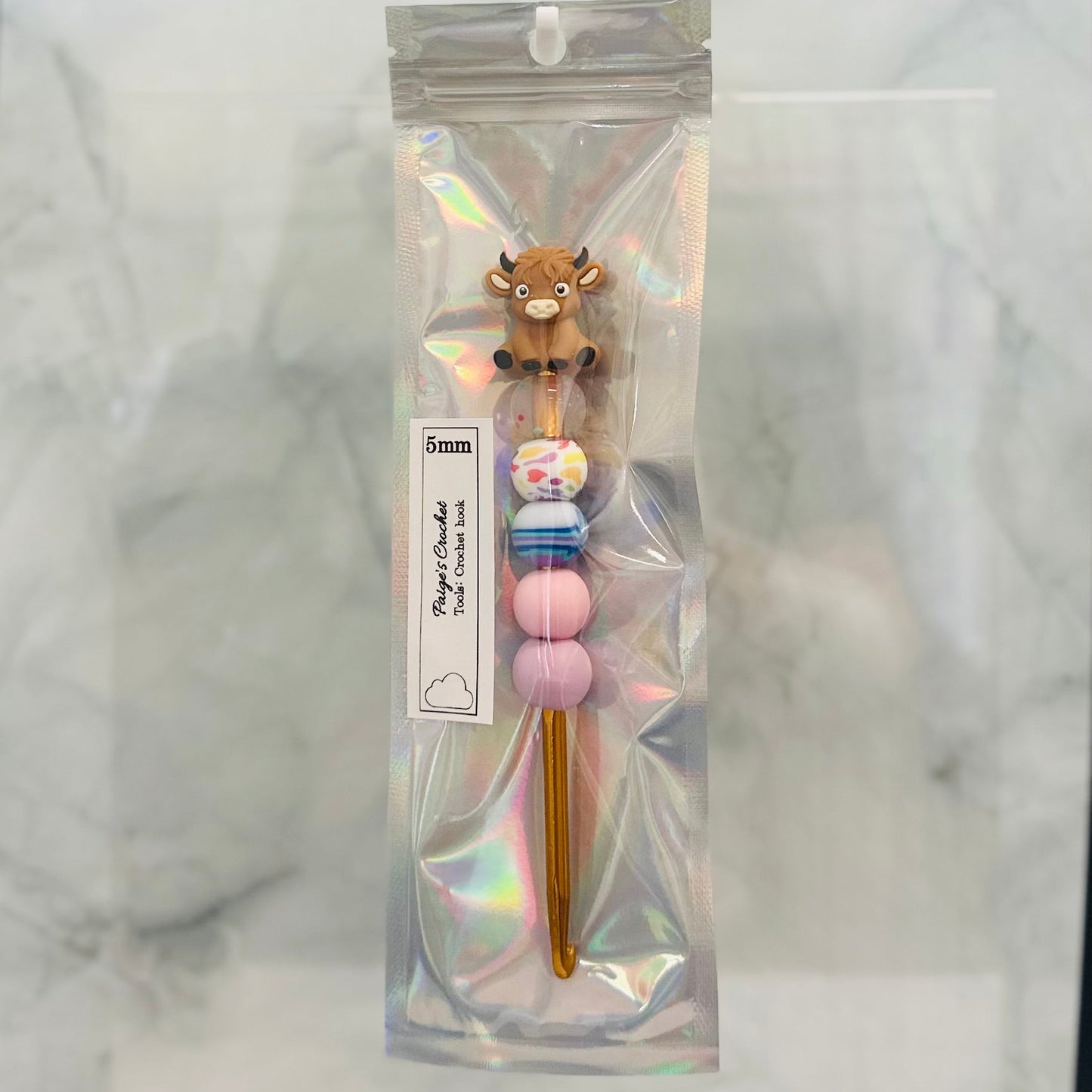 5mm colourful beaded crochet hook with a highland cow sitting on top