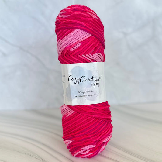 Ball of pink yarn with a label on a white background
