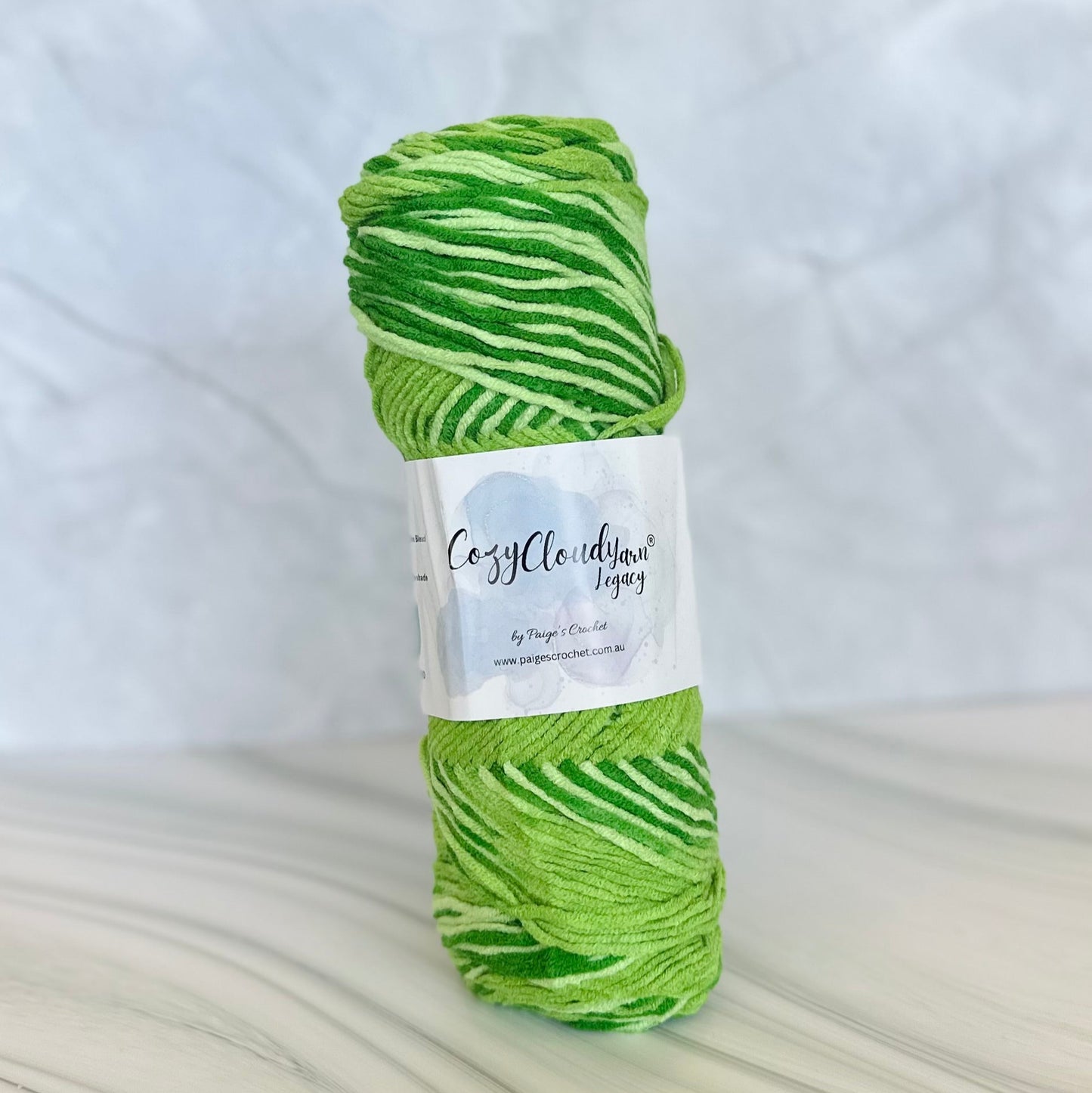 Green skein of yarn with a label on a white background