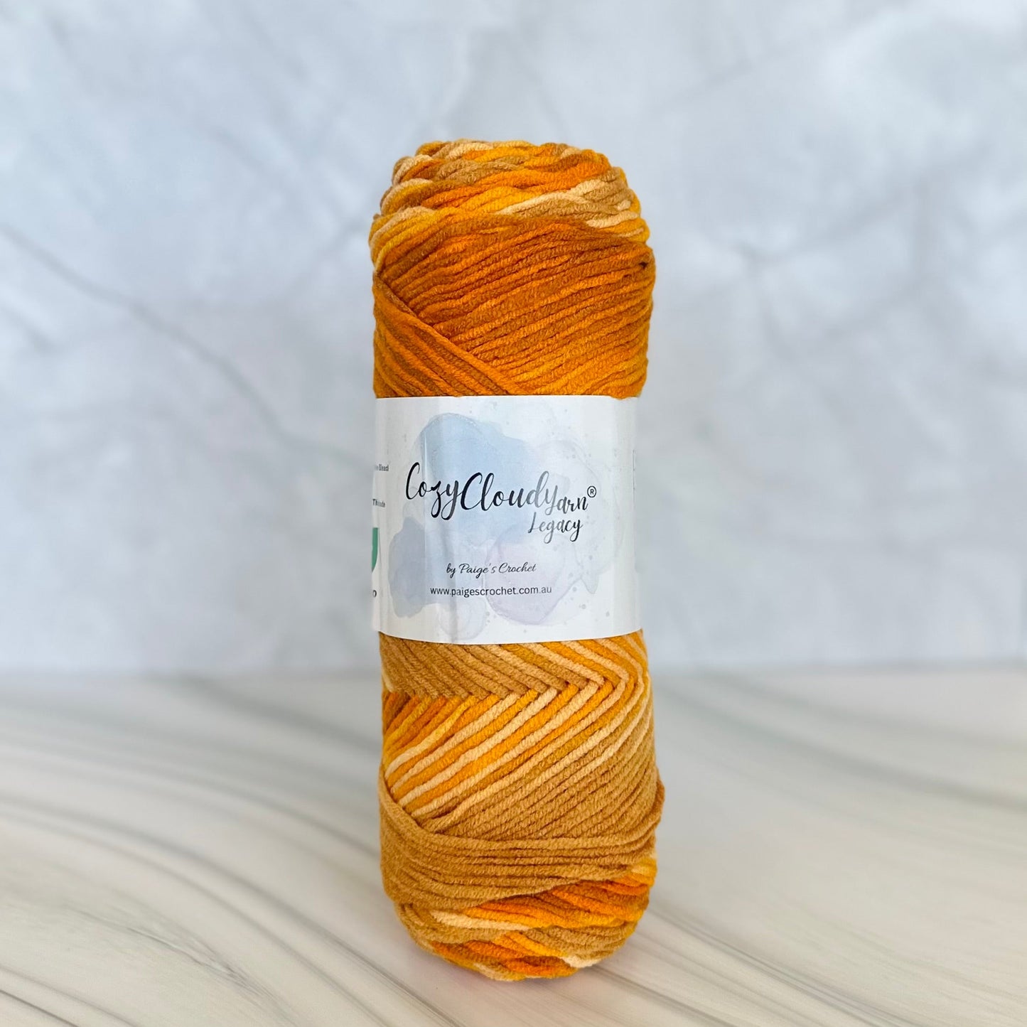orange and brown mixed colour 10 ply acrylic yarn with a cozy cloud yarn label