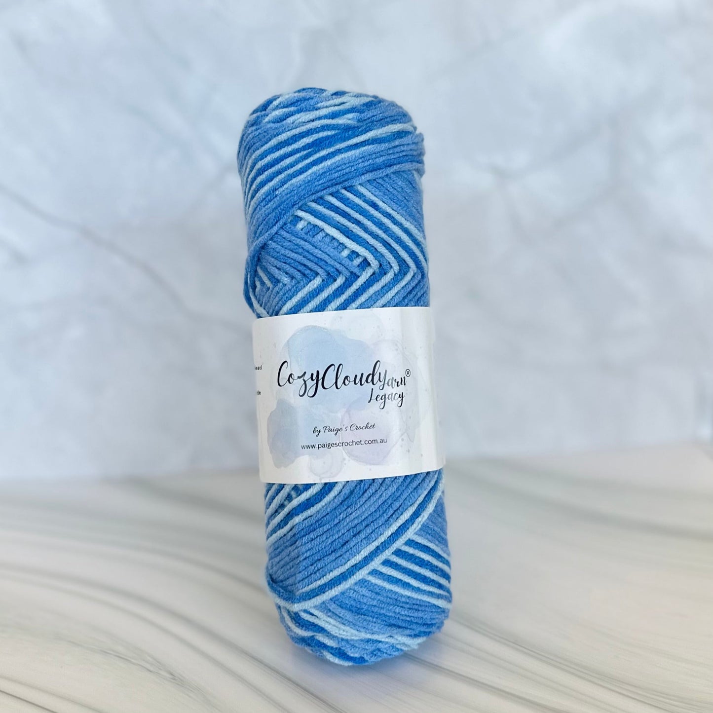 Blue yarn skein with a label on a white background