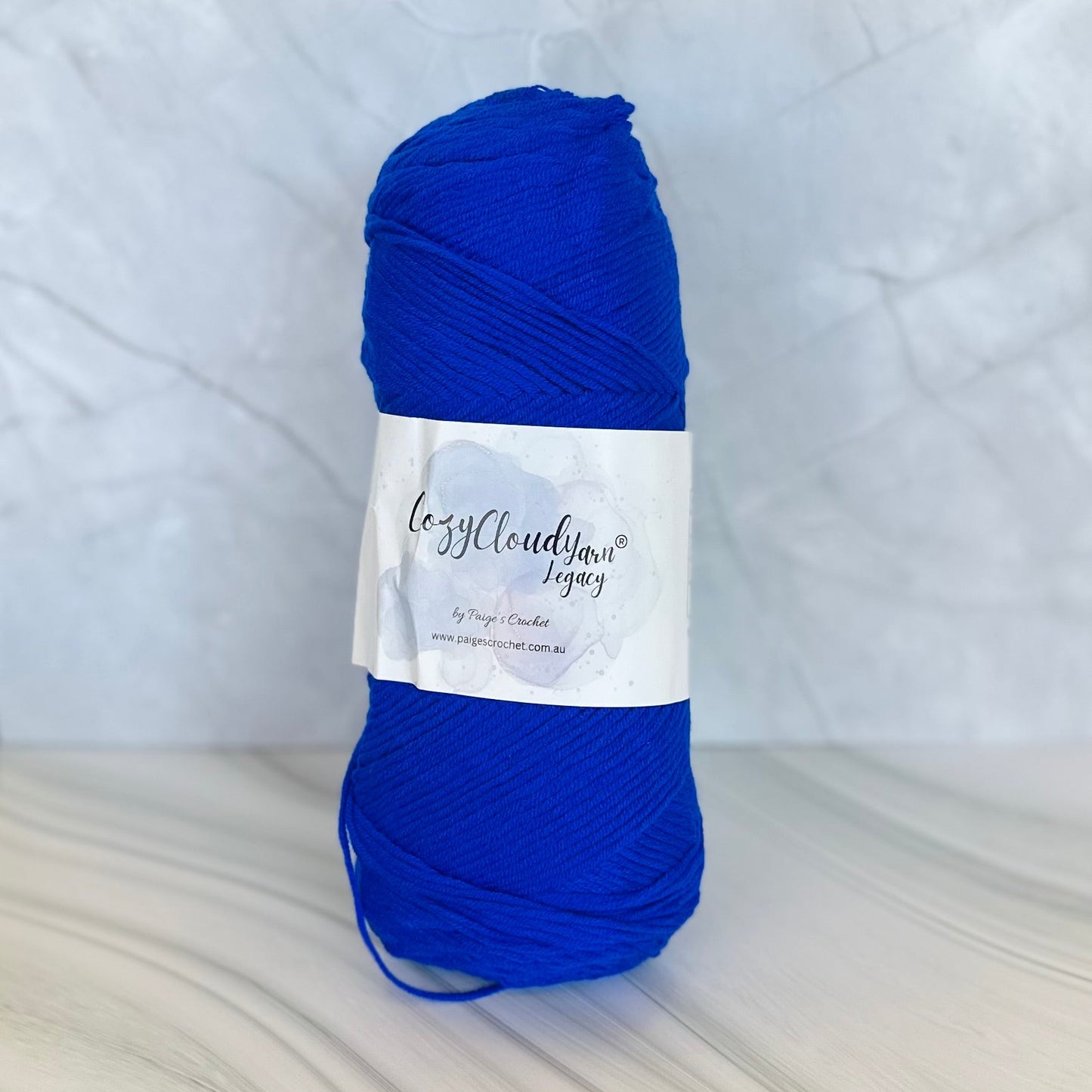 Blue skein of yarn with a label on a white background
