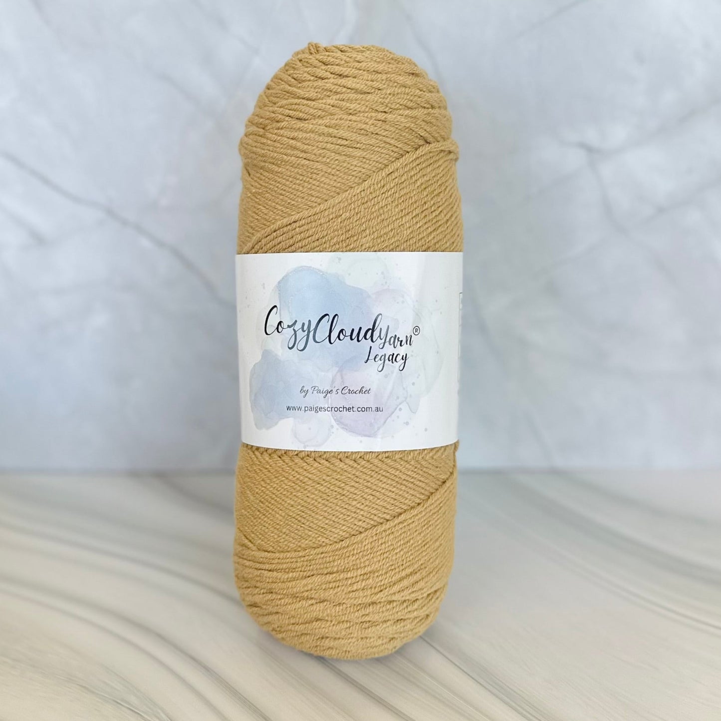 beige Ball of yarn with a label on a textured surface