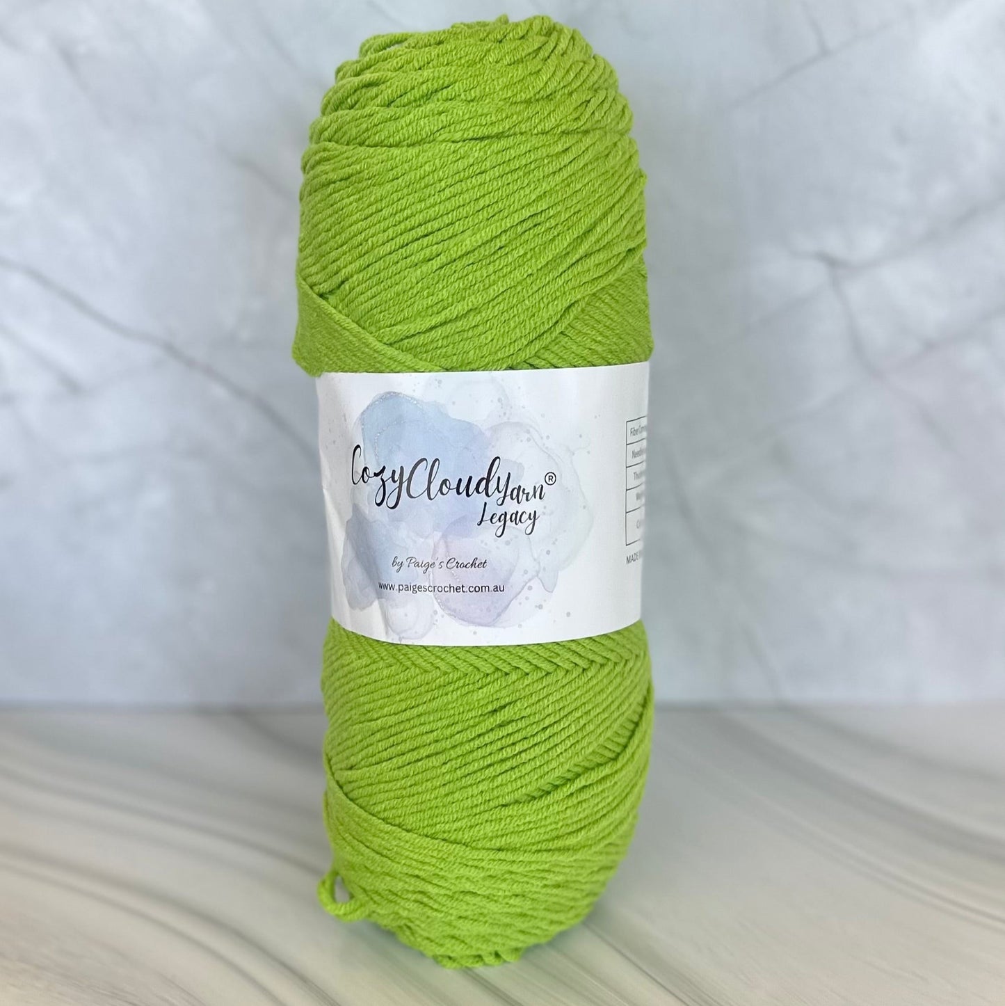 Green skein of yarn with a label on a light background