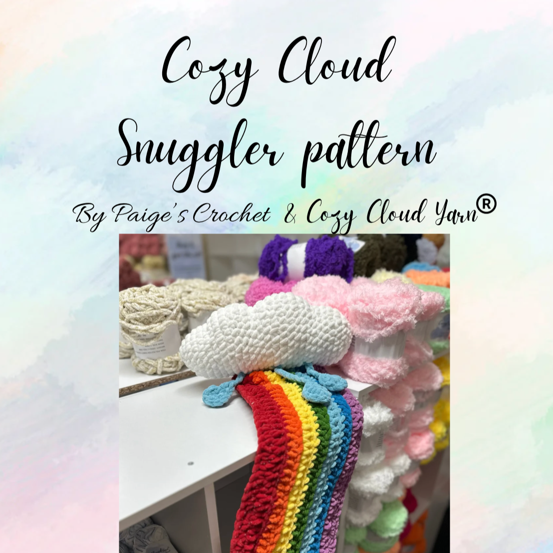 Crocheted rainbow cloud snuggler with yarn on a shelf, featuring Cozy Cloud Snuggler pattern by Paige's Crochet & Cozy Cloud Yarn.