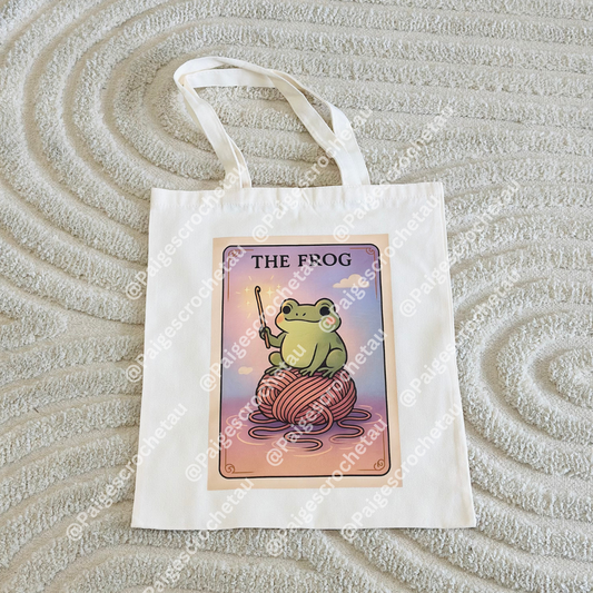 Whimsical Frog crochet tote bag with pastel cloud artwork, ideal for carrying yarn, hooks, and WIP projects