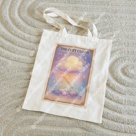 Whimsical Cozy Cloud crochet tote bag with pastel cloud artwork, ideal for carrying yarn, hooks, and WIP projects
