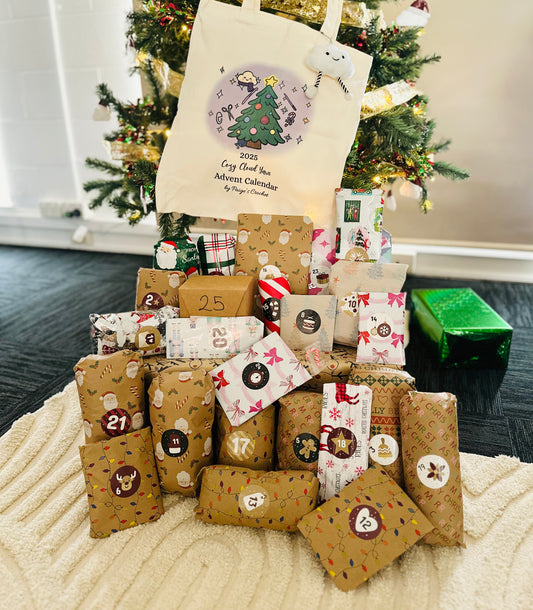 Stack of Christmas-themed packages with a tree in the background