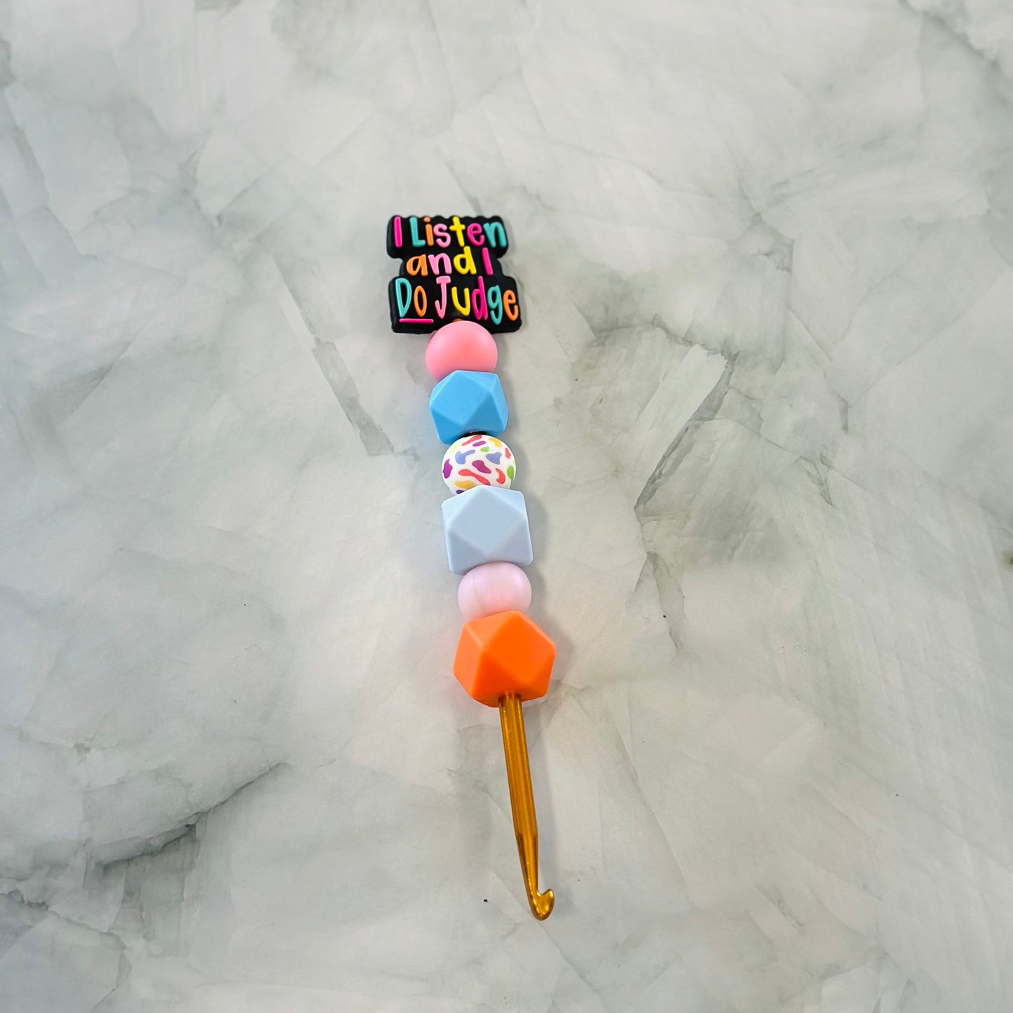 Colorful beaded  crochet hook with a phrase bead  on a textured white background, Best for use with chenille yarn 