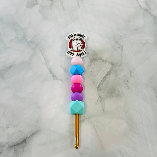 Crochet hook with colorful bead handle on a marble background chenille yarn plush yarn acrylic yarn 