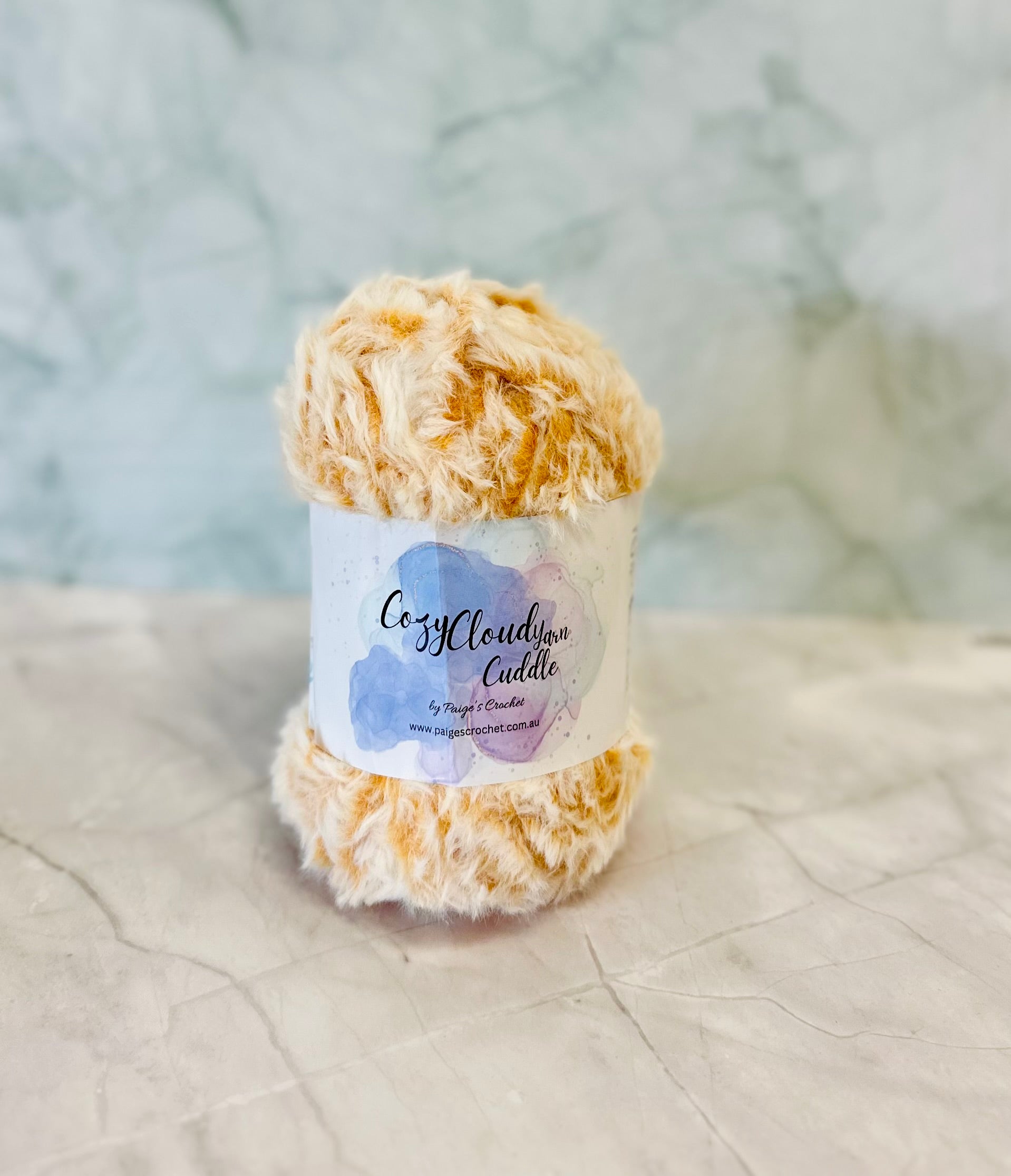 Ball of yarn with a label on a textured surface