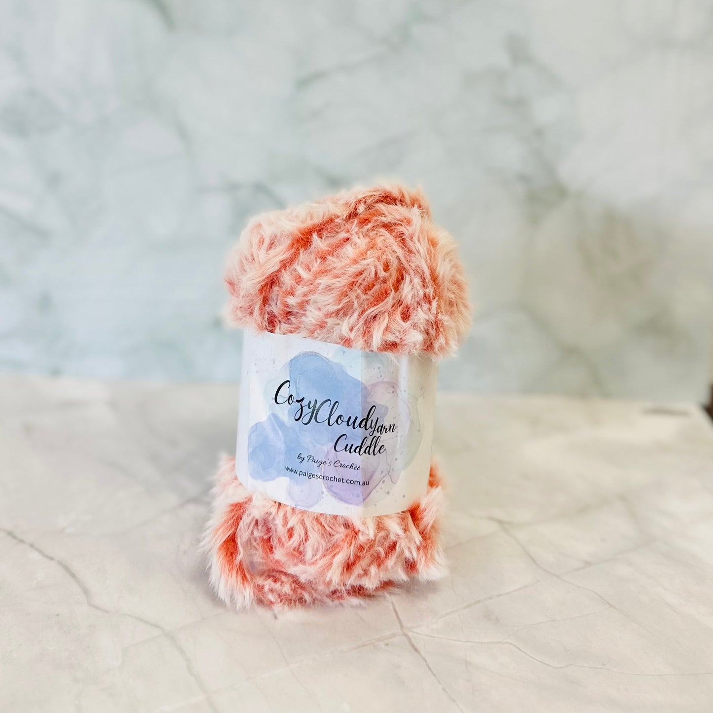 Ball of yarn with a label on a textured surface