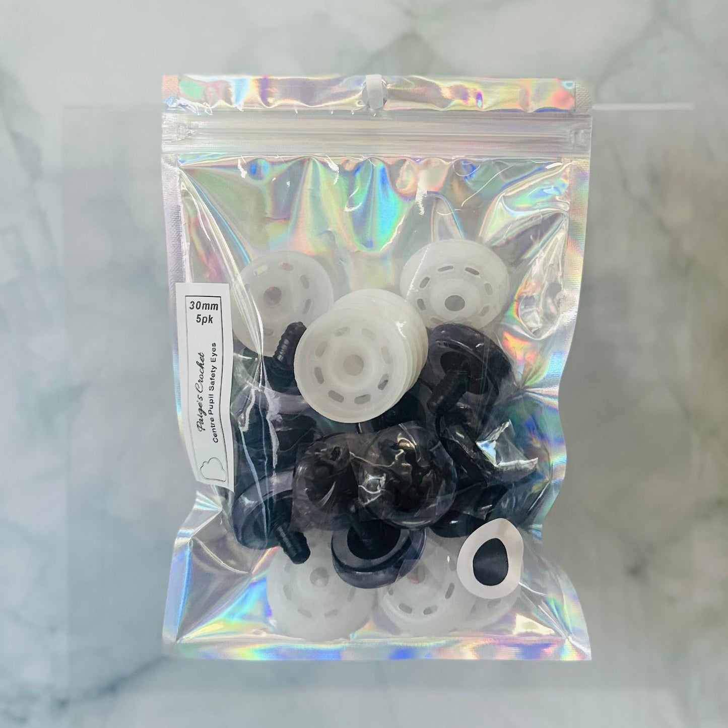 A holographic bag contain 35mm centre pupil safety eyes 