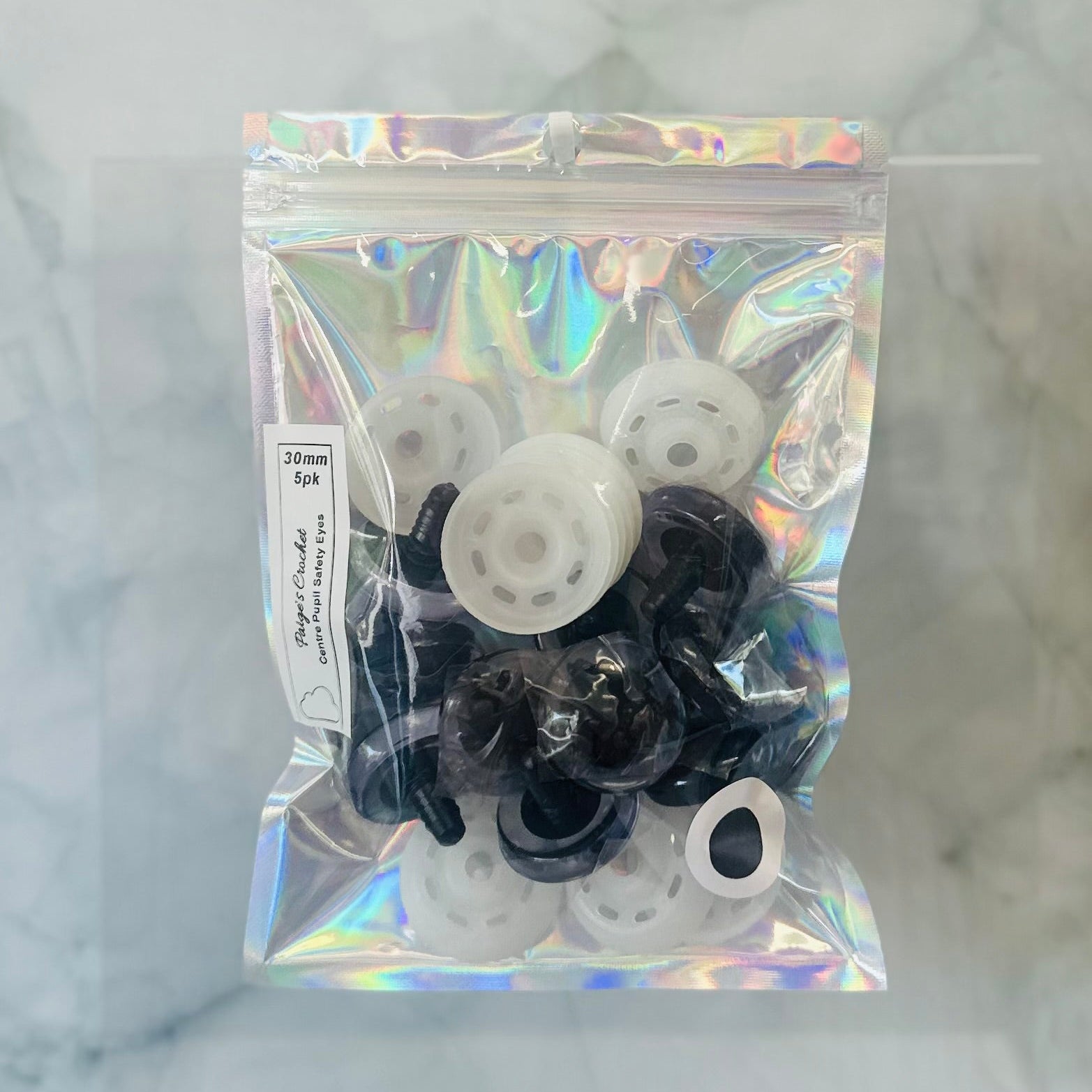 A holographic bag contain 35mm centre pupil safety eyes 