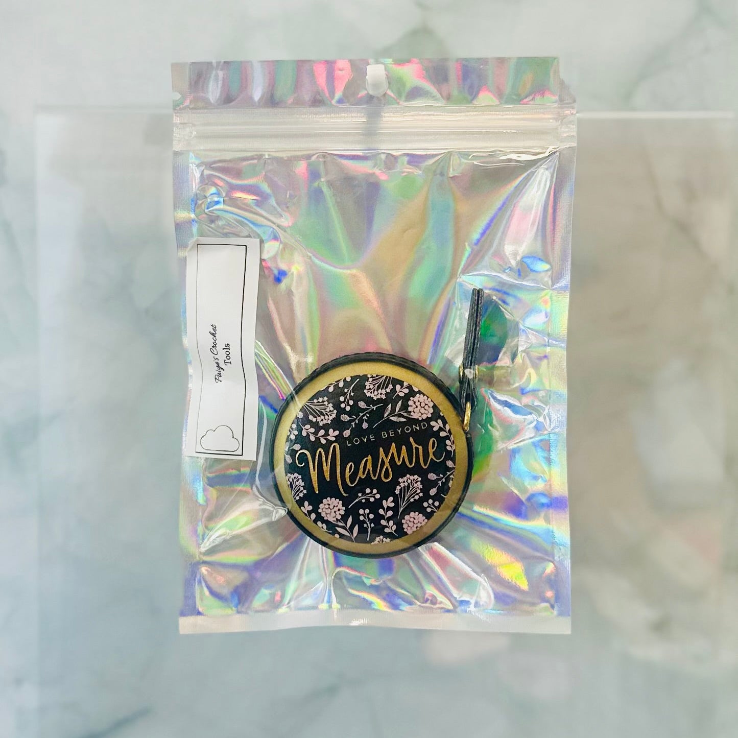 Holographic packaging with a round product featuring 'Measure' text on a marble background