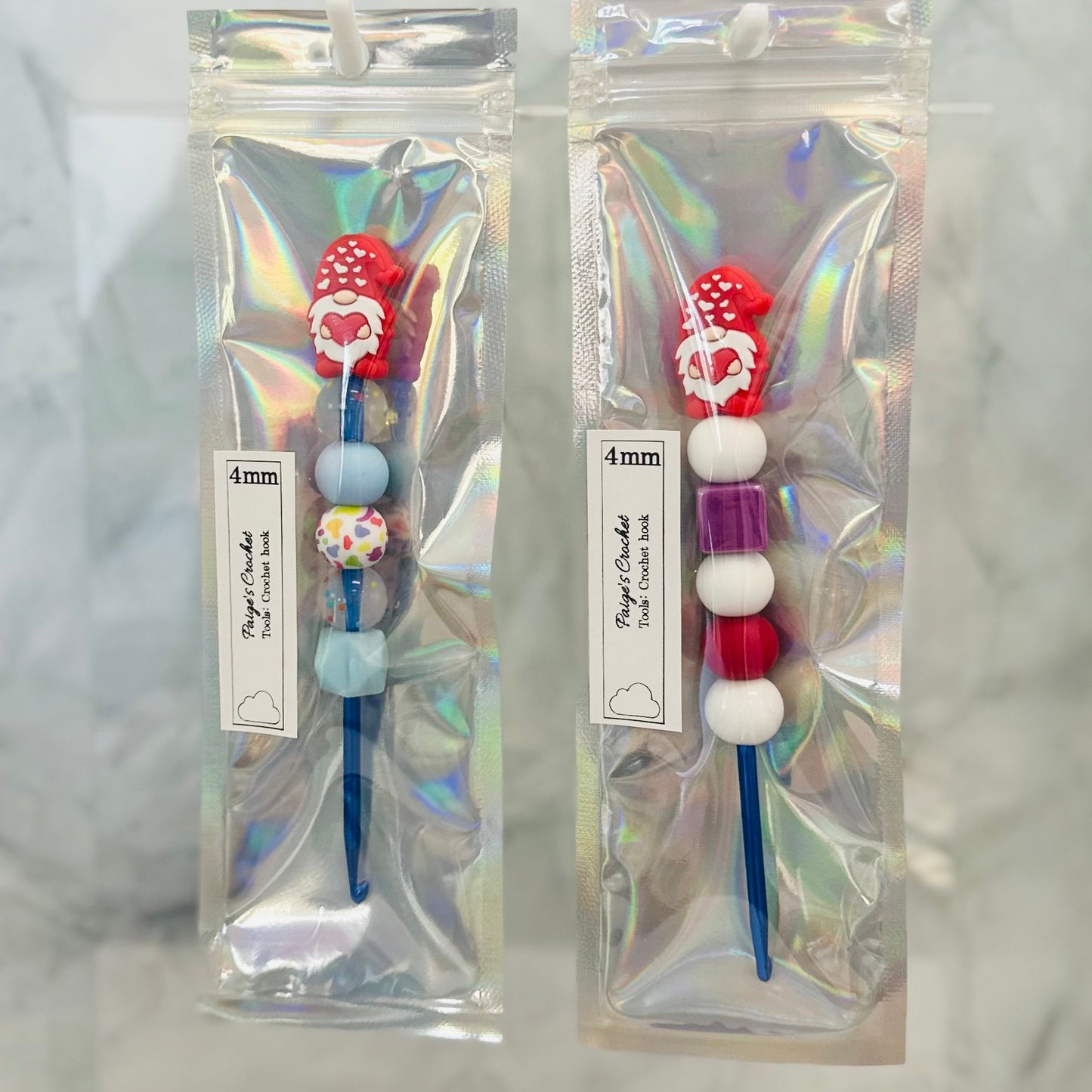 4mm silicone bead crochet hooks , with valentines day themed garden gnomes sitting on top 