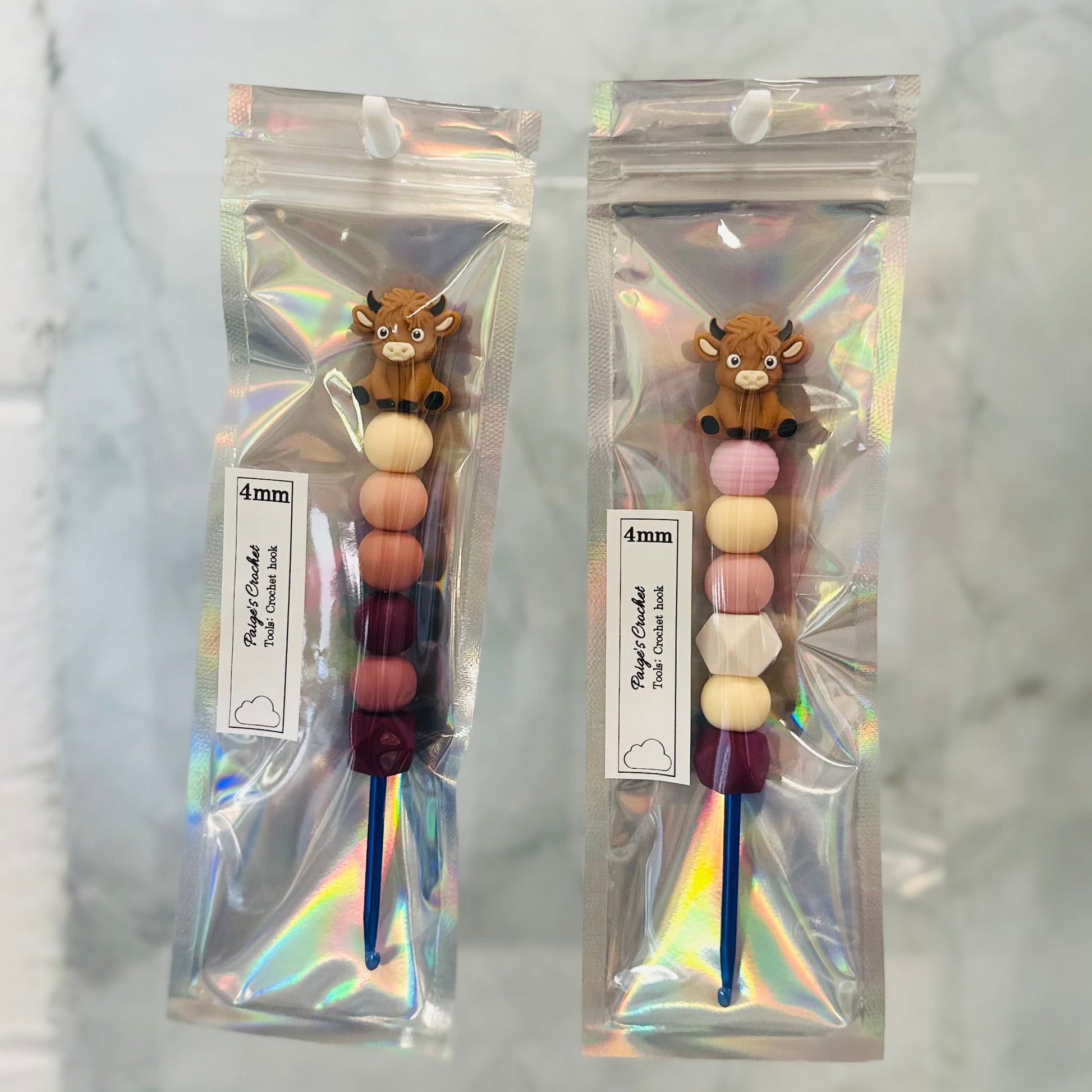 colourful beaded crochet hooks in 4mm with.a highland cow sitting on top 