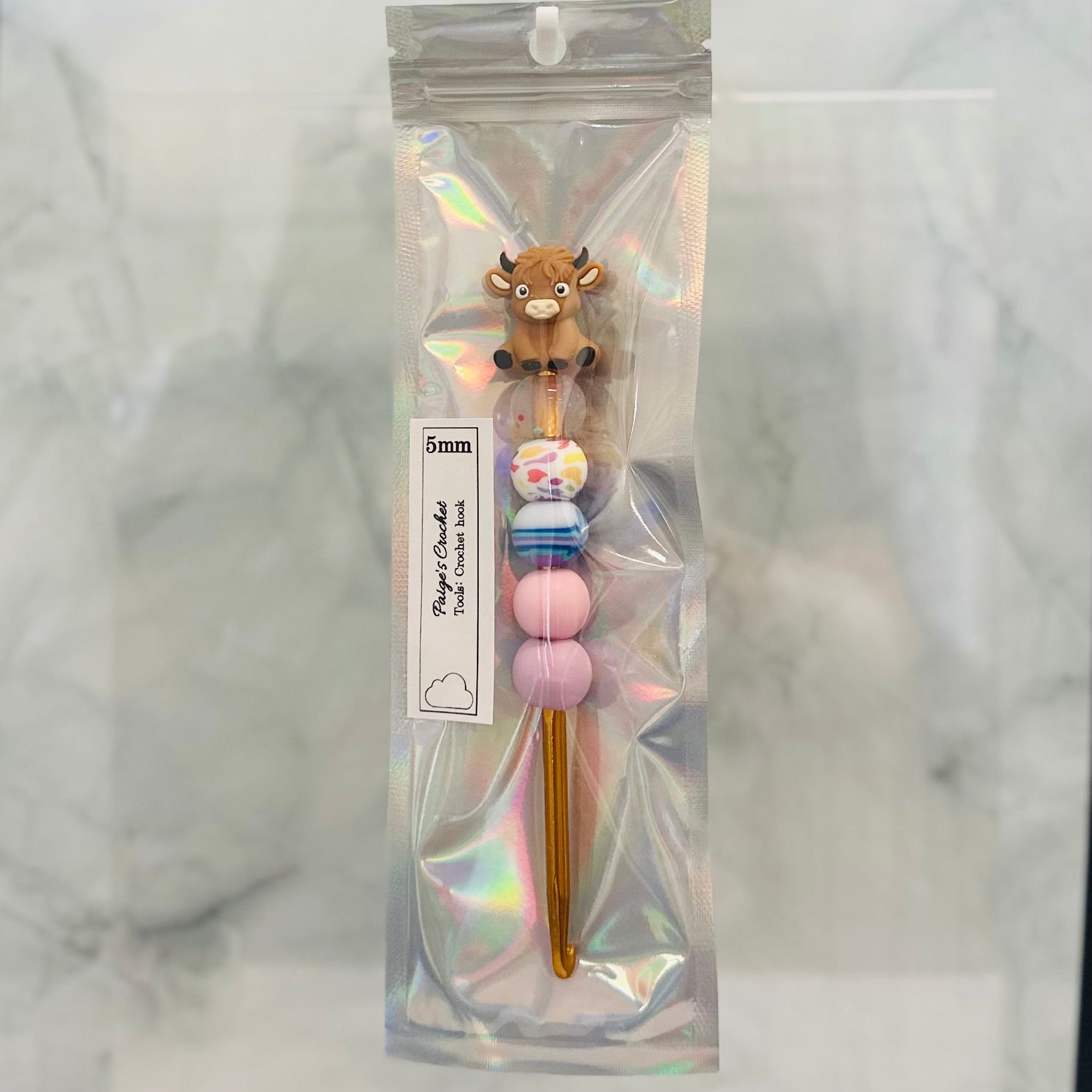 5mm colourful beaded crochet hook with a highland cow sitting on top