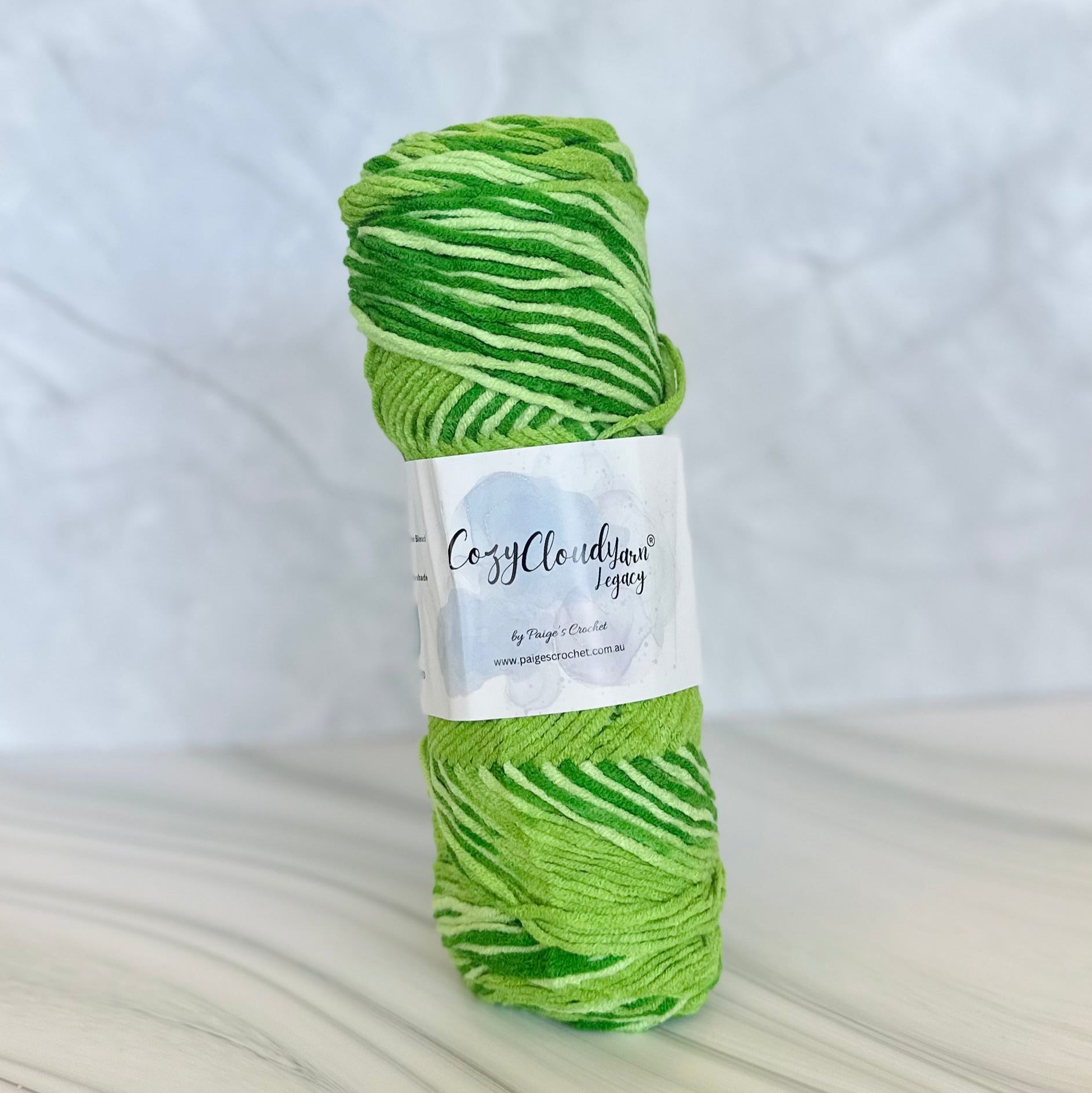 Green skein of yarn with a label on a white background