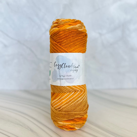 orange and brown mixed colour 10 ply acrylic yarn with a cozy cloud yarn label 