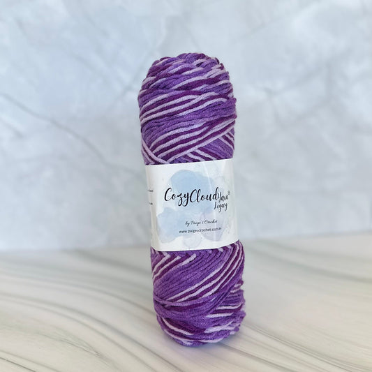 Purple skein of yarn with a label on a white background