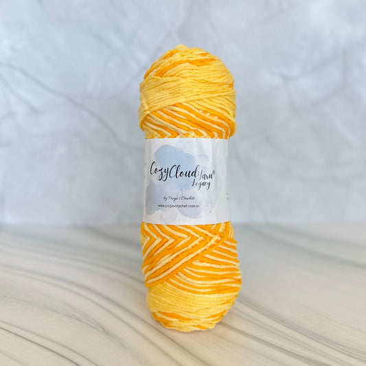 Yellow skein of yarn with a label on a white background