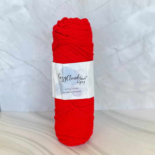 Red skein of yarn with a label on a white background
