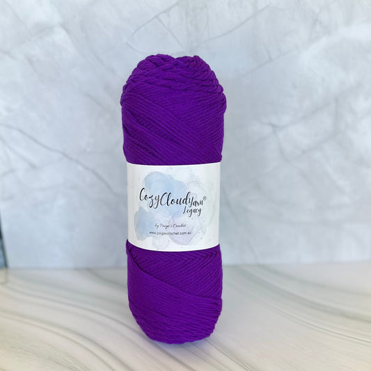 Purple skein of yarn with a label on a white background