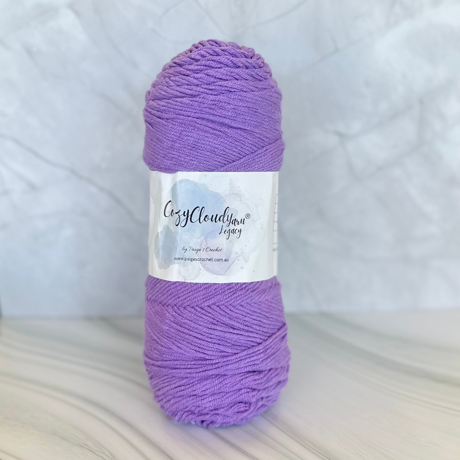 Purple yarn ball with a label on a white background