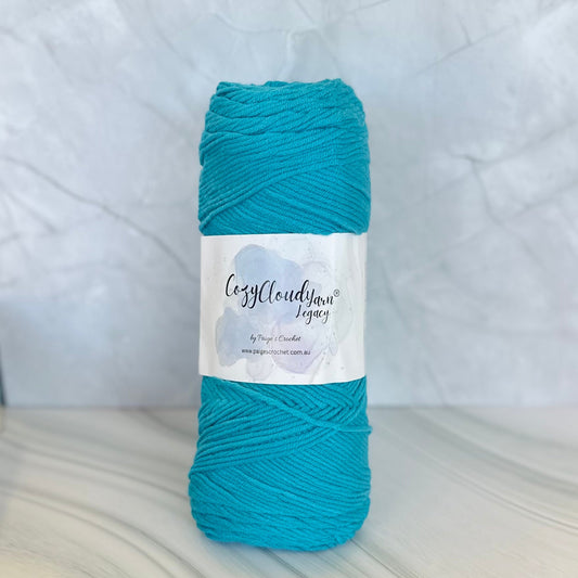 Turquoise skein of yarn with a label on a white background