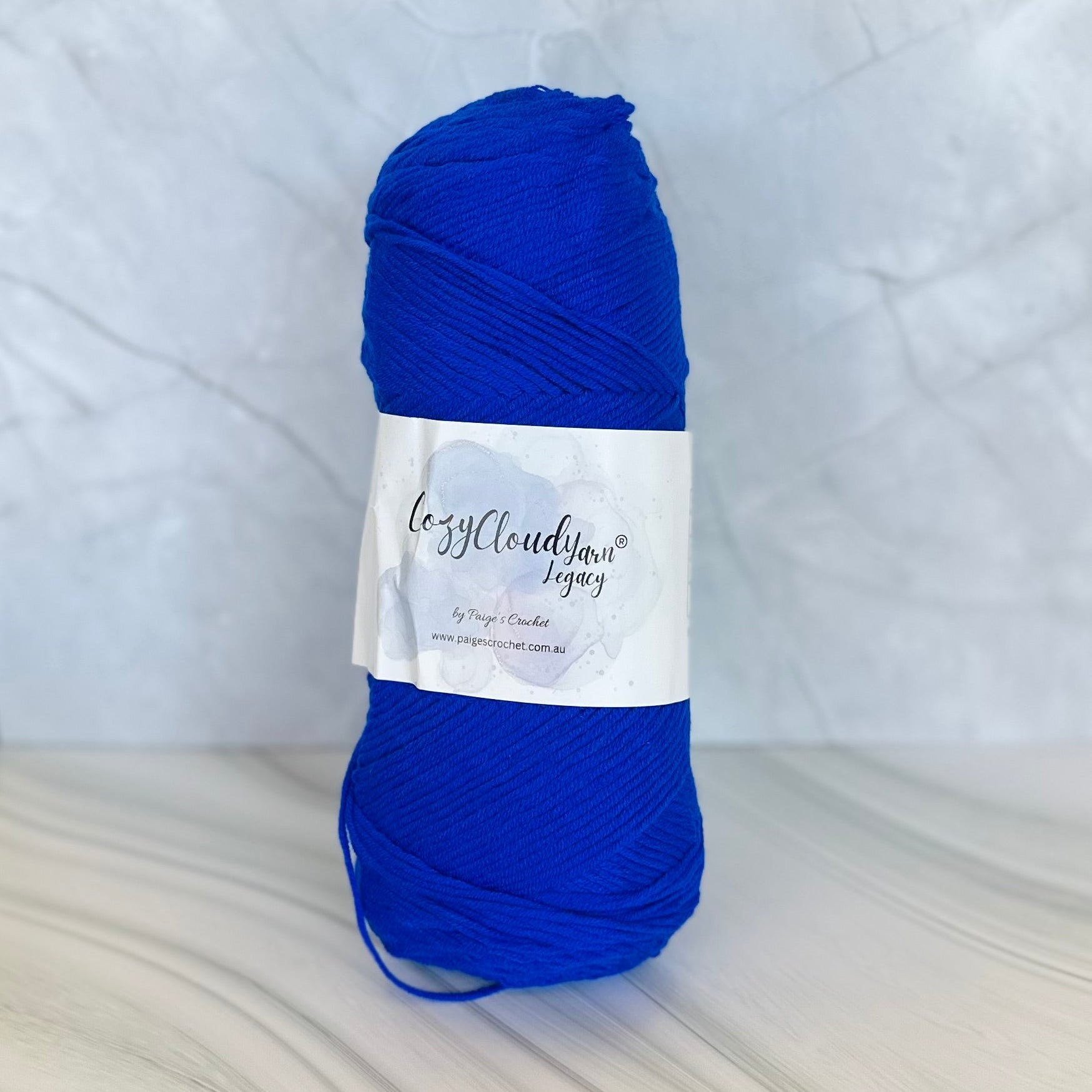 Blue skein of yarn with a label on a white background