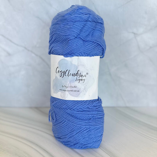 Blue skein of yarn with a label on a white background