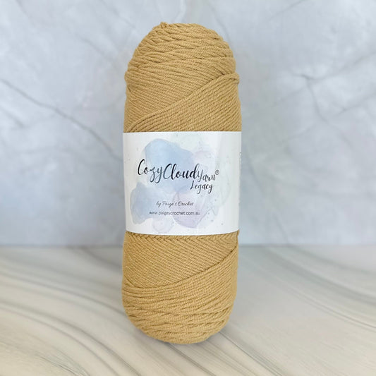 beige Ball of yarn with a label on a textured surface