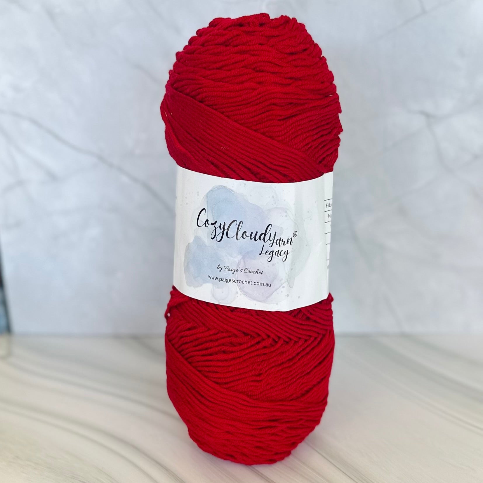 Red skein of yarn with a label on a white background