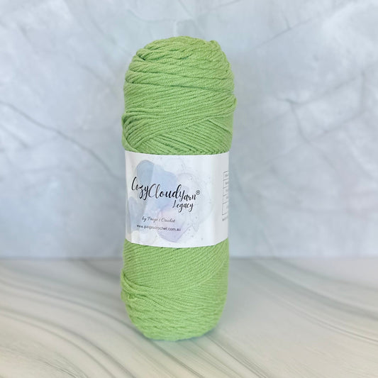 Green skein of yarn with a label on a light gray background
