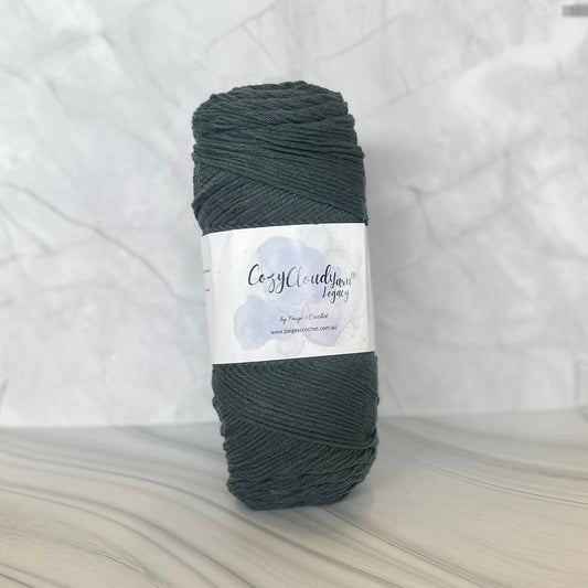 Dark gray skein of yarn with a label on a light gray background